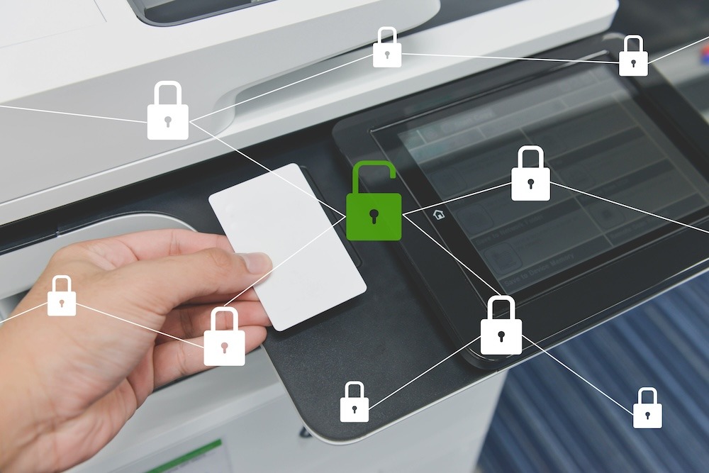 Business man hand is using smart card to printing document with locked and unlocked key. Printer security concept.