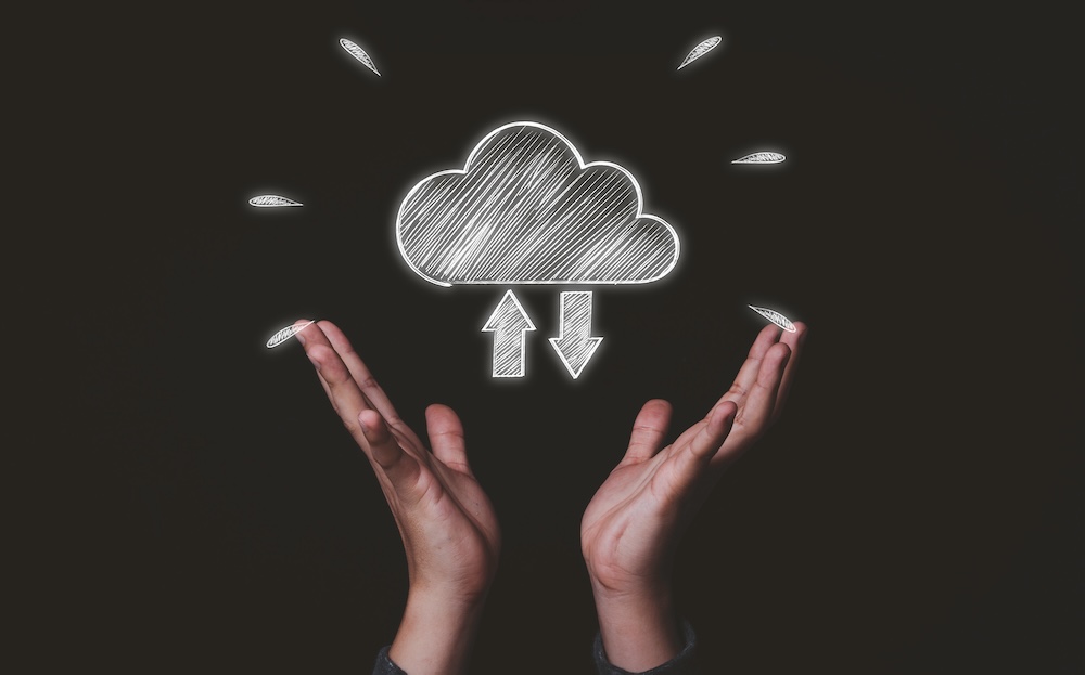 Two hand holding white cloud computing icon from hand drawing , Cloud computer technology is storage for sharing data information cloud printing concept.