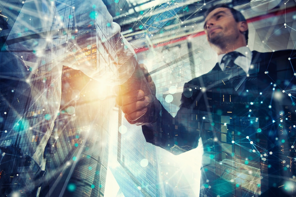 Handshaking business person in the office. technology partner concepts
