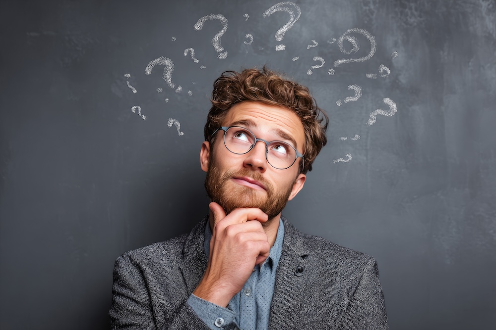 A man with question marks over his head. Concept of what printer to buy.