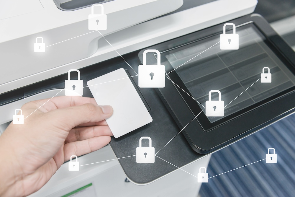 Business man hand is using smart card to printing document with locked key icon for data protection concept
