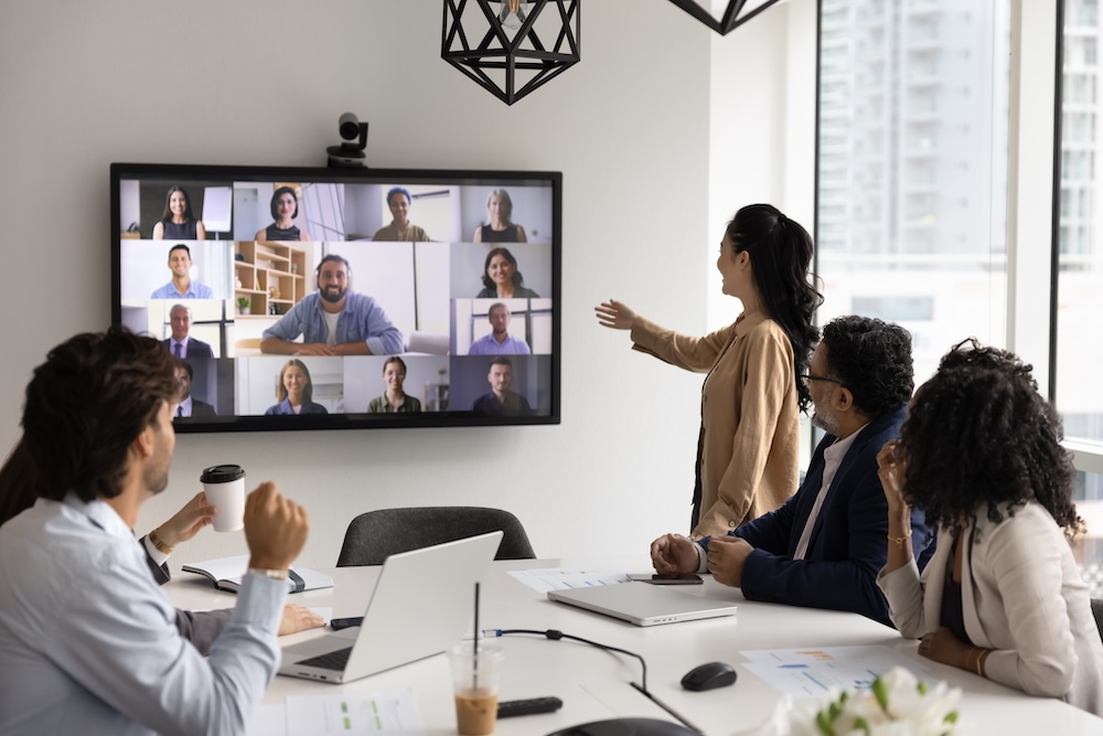 Networking and integration in modern business. Diverse polyethnic office team of coworkers hold video negotiations with remote partners meet investors online on computer screen to discuss project work