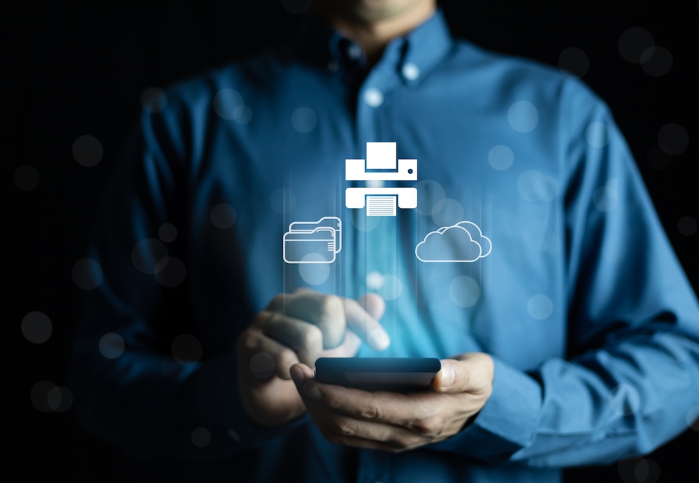 Business professional using cloud printing technology on a mobile device, representing secure cloud printing, remote document access, and modern print management solutions for SMBs.